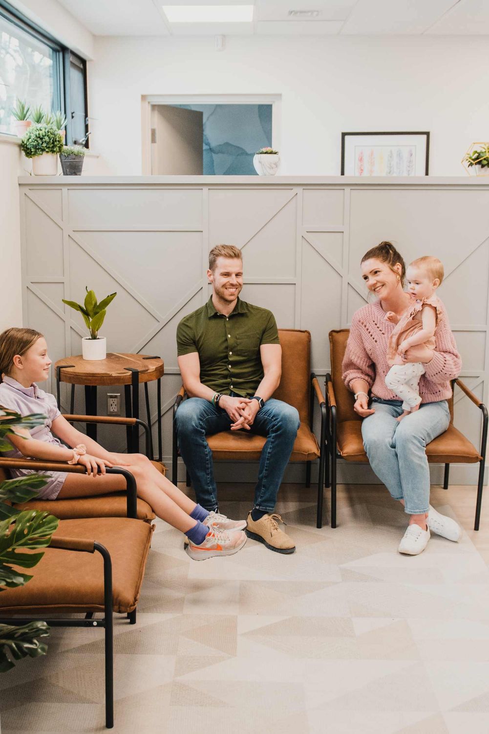 A family chatting in the Elmwood waiting area