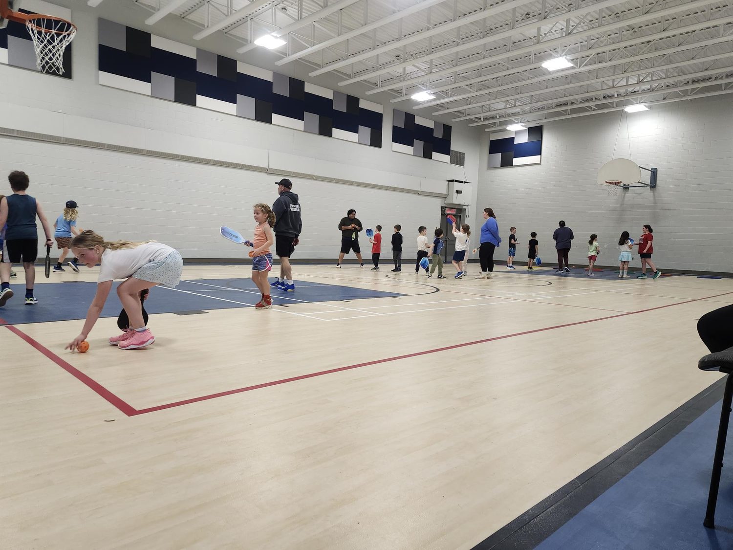 Children and coaches playing pickleball in the Elmwood gymnasium