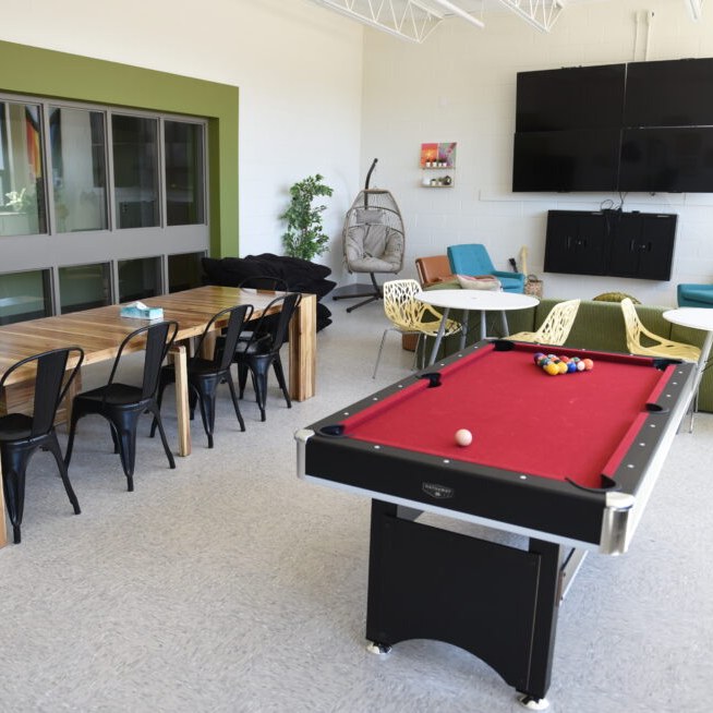 Lounge at the Beauchamp Youth Hub with a pool table, tables and seating